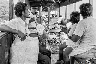 passengers with fruit basket on Niicaragua railroad Managua to Leon Nicaragua by Michael Fluery